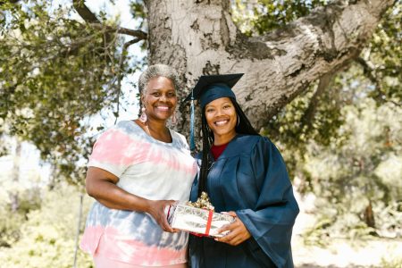 grammy and her graduate standing together; 25 Budget-Friendly Gift Ideas For Grads