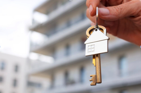 hand holding a key; Co-Buying Real Estate with Friends A Smart Strategy