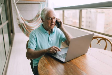 man sitting at table working; Why 'Semi-Retirement' is the Ultimate Power Move