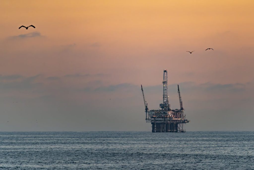 offshore oil rig at sunset; How to Protect Your Wealth and Wallet from Rising Oil Prices