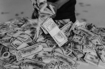 black and white photo of cash; Where Should Entrepreneurs Put Extra Cash?