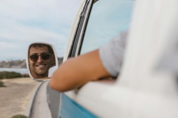 man's face in a mirror, driving in a car; Gas Price Travel Pivot Why Near-Cationing