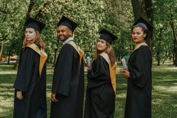 grads in gowns lined up together; Graduation How to Financially Prep for Your Kid’s Next Chapter