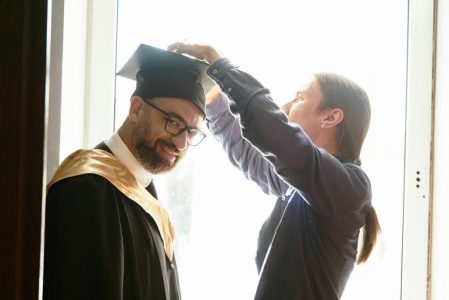 graduate having his cap placed on head; Student Loan Repayment Strategy That Saved Me $23,000