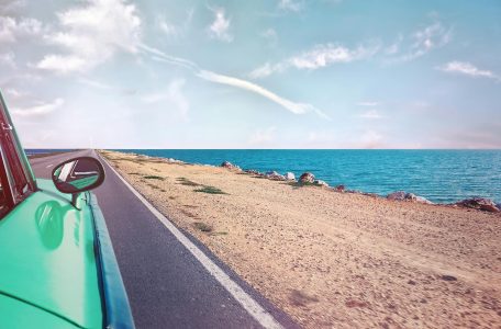 driving along the road site-seeing; Surging Fuel, Rising Fares 2026 Summer Travel Survival Guide