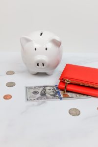 piggy bank and a red wallet; Tariffs Destroying Retirement Savings Moves to Fight Back