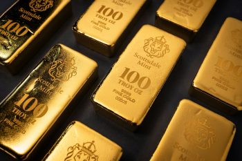 beautiful gold bars on black background; What Gold Signals for Your Retirement Portfolio