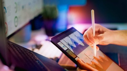Person using stylus on tablet with charts document open; Browser-Based Document Tools