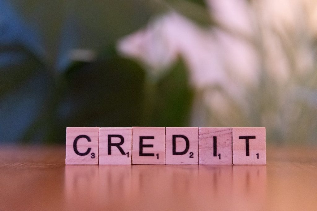 wooden block letters saying credit; Credit Score Myth That Is Costing You Thousands