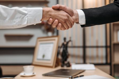 a hand shake with a financial advisor; Estate Planning Mistake That Could Leave Your Family With Nothing