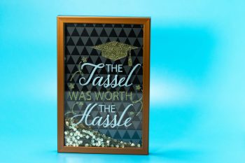 sign saying The Tassel The Hassle; Graduation gift Why Savvy Entrepreneurs Give Assets Not Just Cash