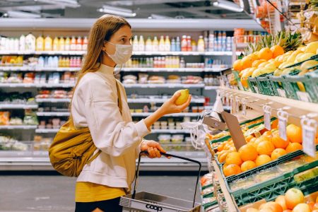 woman at the grocery market; How I Cut My Grocery Bill by $400 a Month