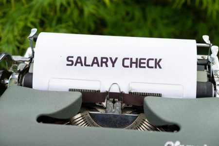 salary check in an analog typewriter; How to Safely Pay Yourself Without Starving Your Startup