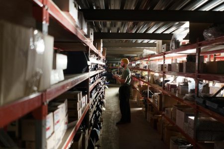 man looking in warehouse at the inventory; Inventory Management Just-in-Time to Just-in-Case