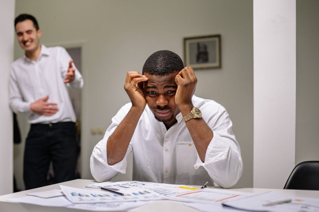 man getting yelled at and getting laid off; layoff-at-45-taught-me-about-money