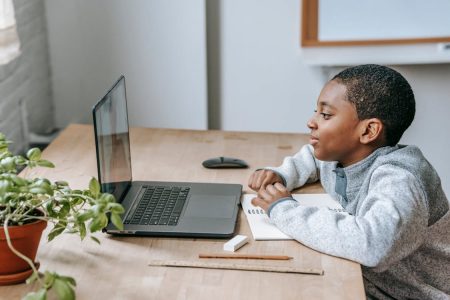 Parent and college student reviewing financial aid and savings documents together