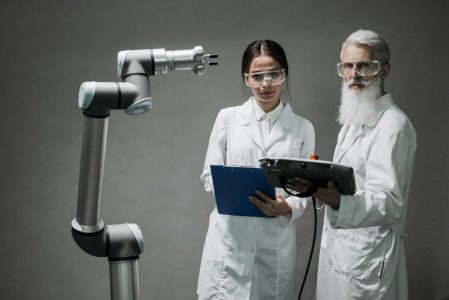 two people in a lab working on tech; Automation and Outsourcing—Do Both to Survive Inflation