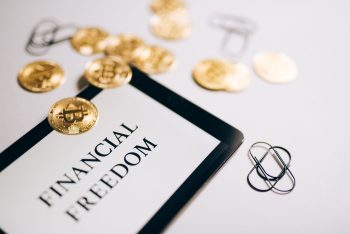 sign saying financial freedom with money sitting on it; Being Rich Won’t Save You But Financial Freedom Will