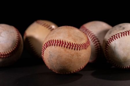 beautiful used baseballs on a black background; Entrepreneur All-Star Lineup Build a Winning Roster