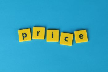 price on bold yellow tiles on a turquoise background; Entrepreneur’s Playbook for Raising Rates and Prices