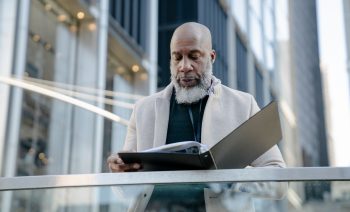 retiree looking at his books; Entrepreneurs Throw Out the Traditional Retirement Playbook