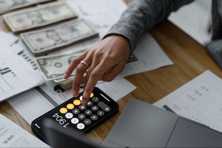 Person calculating financial checklist; Financial Checklist Moving