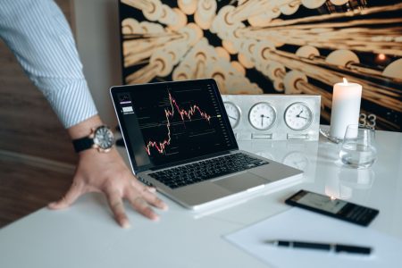 man leaning on table with stock news on computer; Investors pause the AI stock rally
