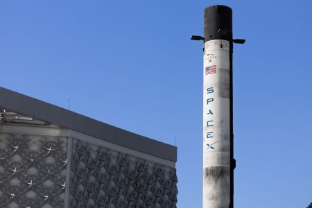 spacex rocket launch with blue sky in background; Musk rocket company to acquire Cursor