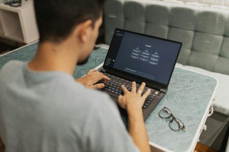 man working at his desk setting up automation; ROI of Automation Not About Efficiency, It’s About Freedom