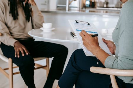 man working with finance person on how to retire early; Retired Three Things I Would Do Differently