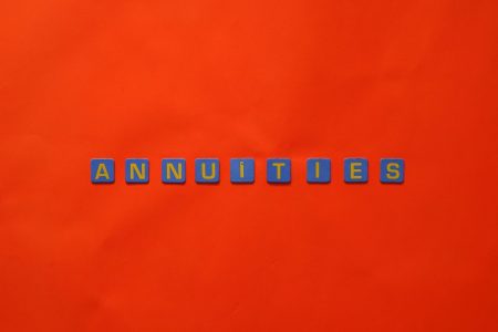 annuities in blocks on an orange background; Why BlackRock, Vanguard, and Fidelity Are Betting on Annuities