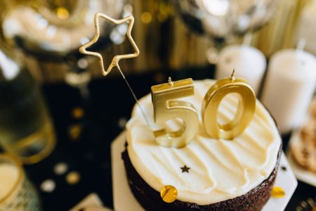 the number 50 sitting on top of a birthday cake