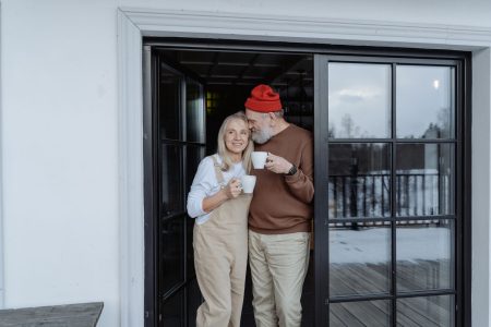 retired couple happy in a smaller home; Downsizing in Retirement Does ItSave You Money?