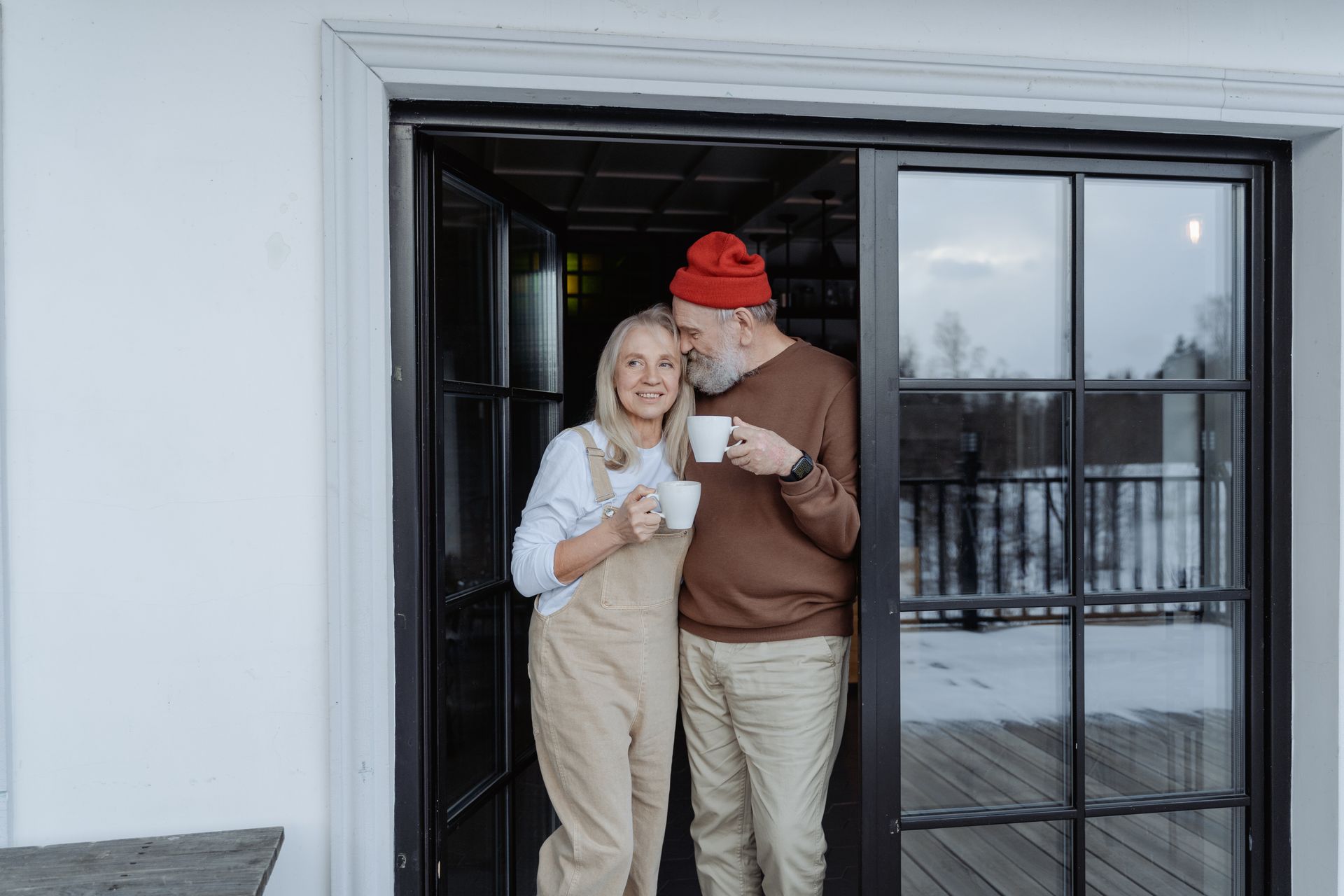 retired couple happy in a smaller home; Downsizing in Retirement Does ItSave You Money?