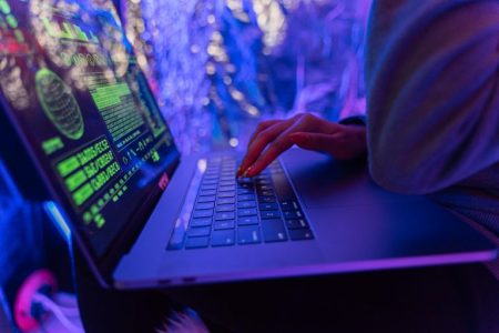 person sitting at computer and getting paid; Get Paid Faster With Digital Invoicing