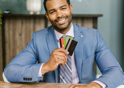 exec holding a bunch of credit cards; How to Pay Off Credit Card Debt Fast