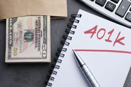 a stack of bills and a 401(k); Protect Your Retirement Savings From a Market Crash