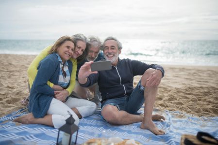 young family and grandparents sitting on a beach; Why the Longevity Economy Is the Ultimate Entrepreneurial Playground