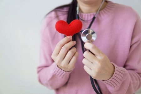nurse holding a heart for a child patient; Charitable in Retirement Donating to Pediatric Cancer Charities