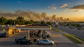 cars at the gas pump; Cheaper Gas Brings an Environmental Trade-Off
