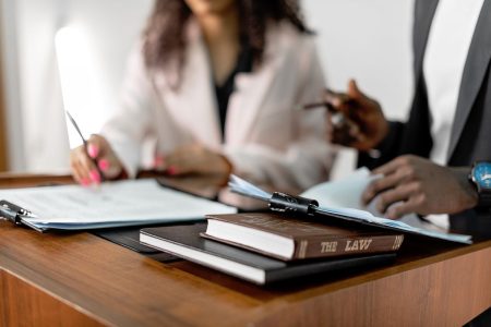 Close-up photo of two divorcees reviewing files on desk; divorce custody retirement savings