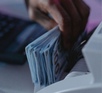 a bank teller getting money for the client at a bank; How to Choose the Right Business Bank Account