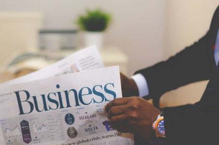 an analog newspaper with Business on the front; How to Improve Cash Flow in a Small Business