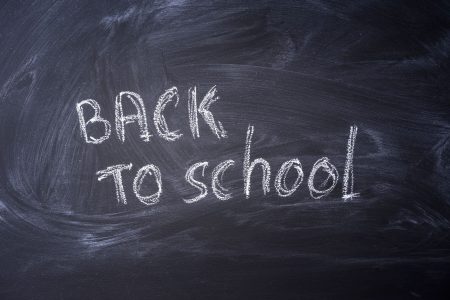 an old fashioned school black with white chalk writing saying back to school; How to Reset Operations, Balance Family, and Win Q4