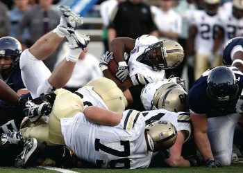 a football team in action on the field; Offense Sells Tickets, Defense Wins Championships