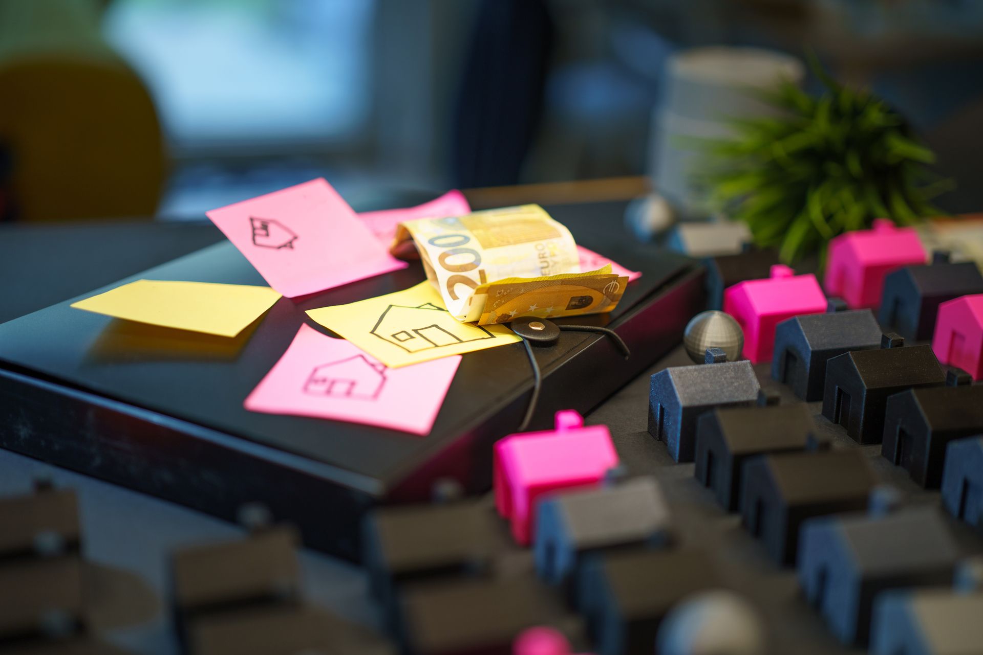 black keyboard with pink houses inserted and sticky notes on the side; Should You Pay Off Your Mortgage Early or Invest