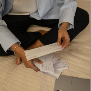 person counting up the check deposits they have received