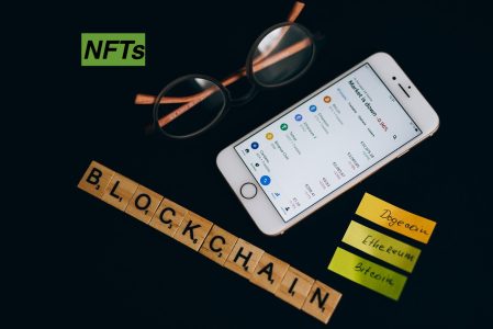 black background with blockchain written out in wooden tile lettering; Tax Break Hiding in Your Dead NFT Wallet