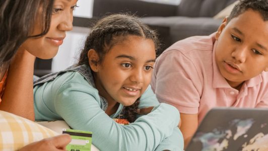 a parent teaching her children about money; Teach Your Kids About Money at Every Age