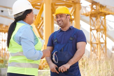 A contractor and a boss at a work site; Contractor vs Employee How to Classify